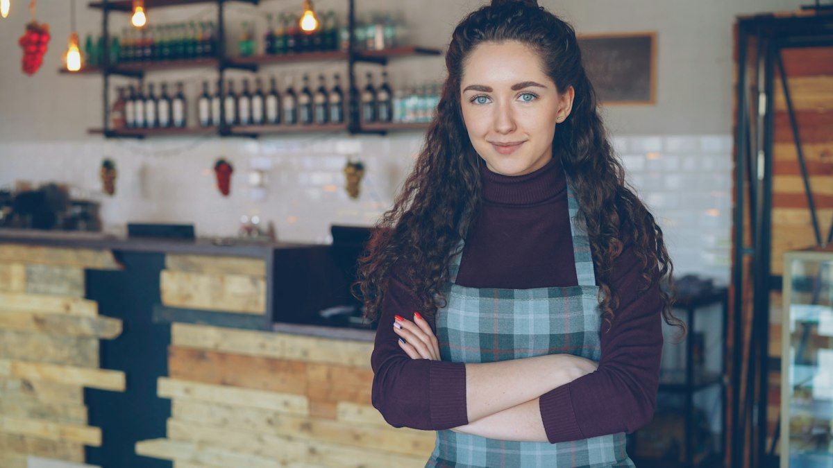 A smiling owner in her coffee shop