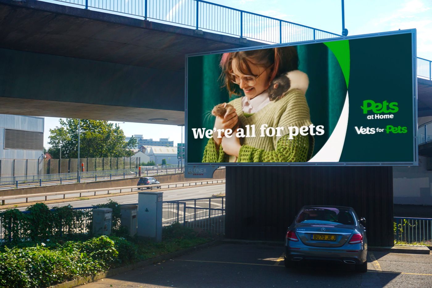 A large digital roadside billboard advertising Pets at Home