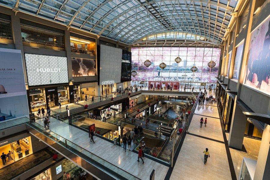 Digital screens inside a busy shopping centre