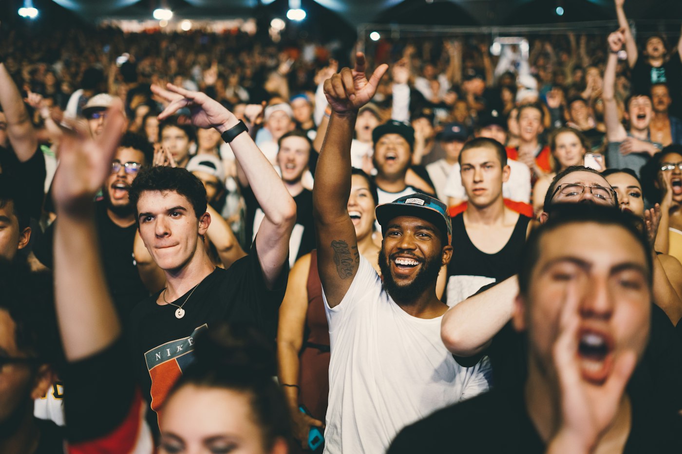 An excited crowd cheering at a live event